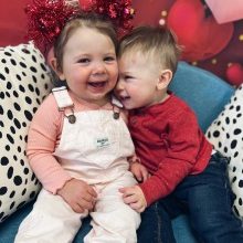 Two toddlers smiling