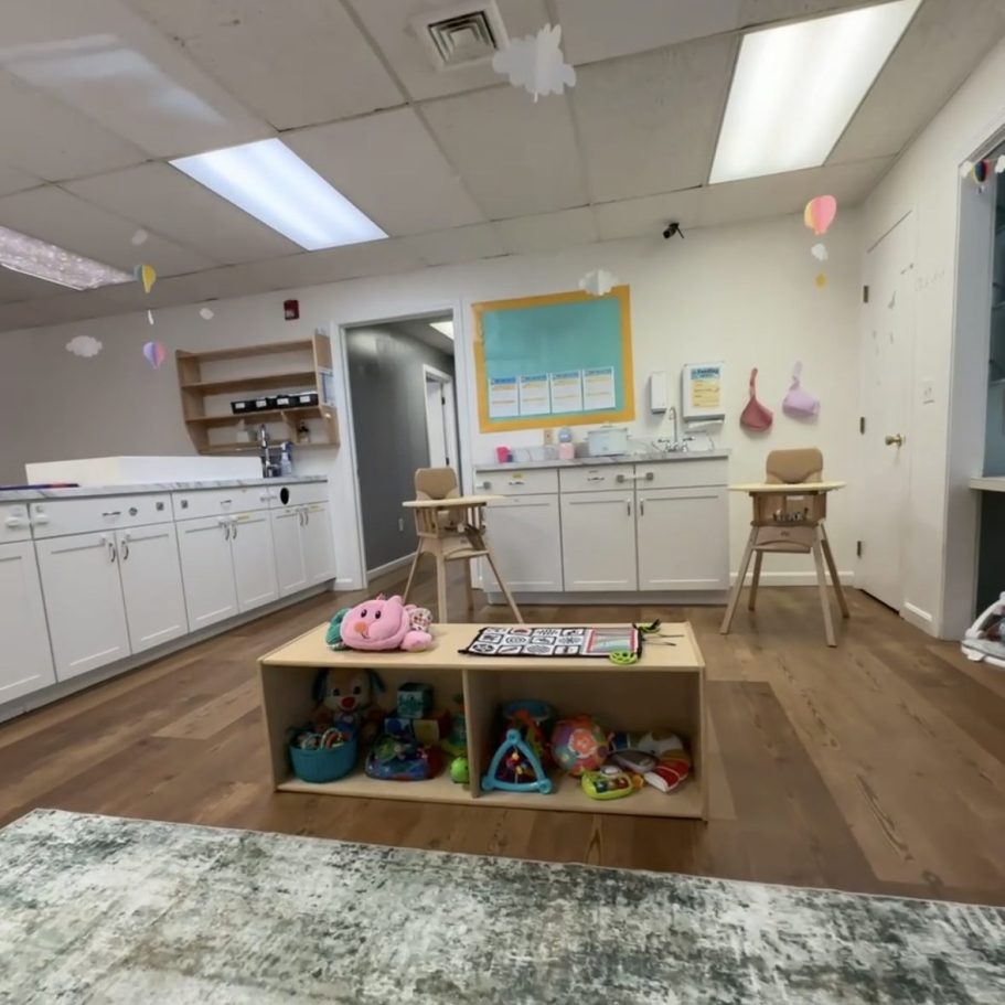 Photo displaying the kitchen, highchairs and toys.