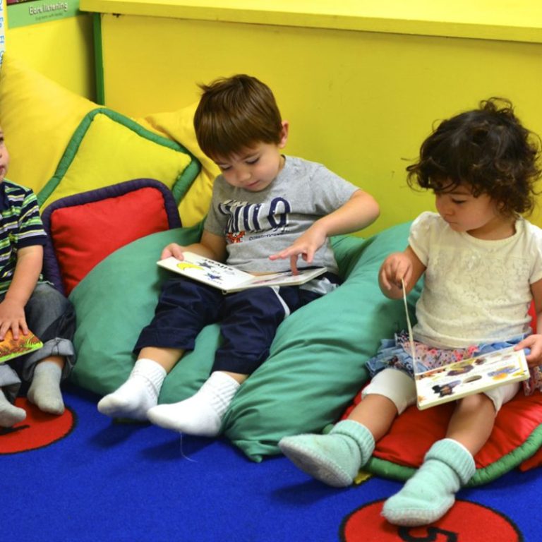 Children reading on beanbag chairs
