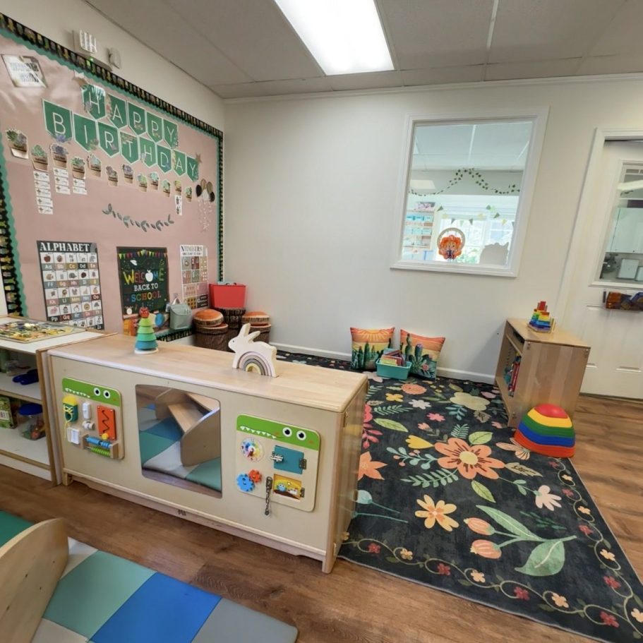 Comfy carpet area with different toys and circle time wall.