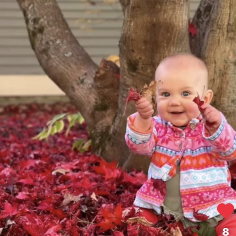 Smiling baby playing with toys