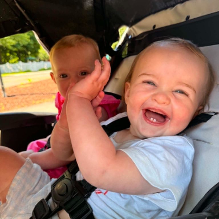 Smiling baby in a stroller