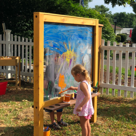 A child painting outdoors