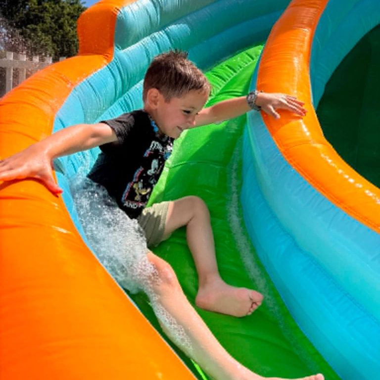 Child going down water slide