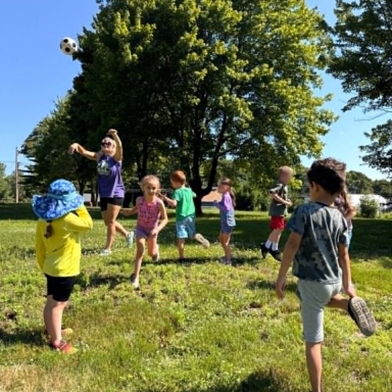 Children playing in field of grass