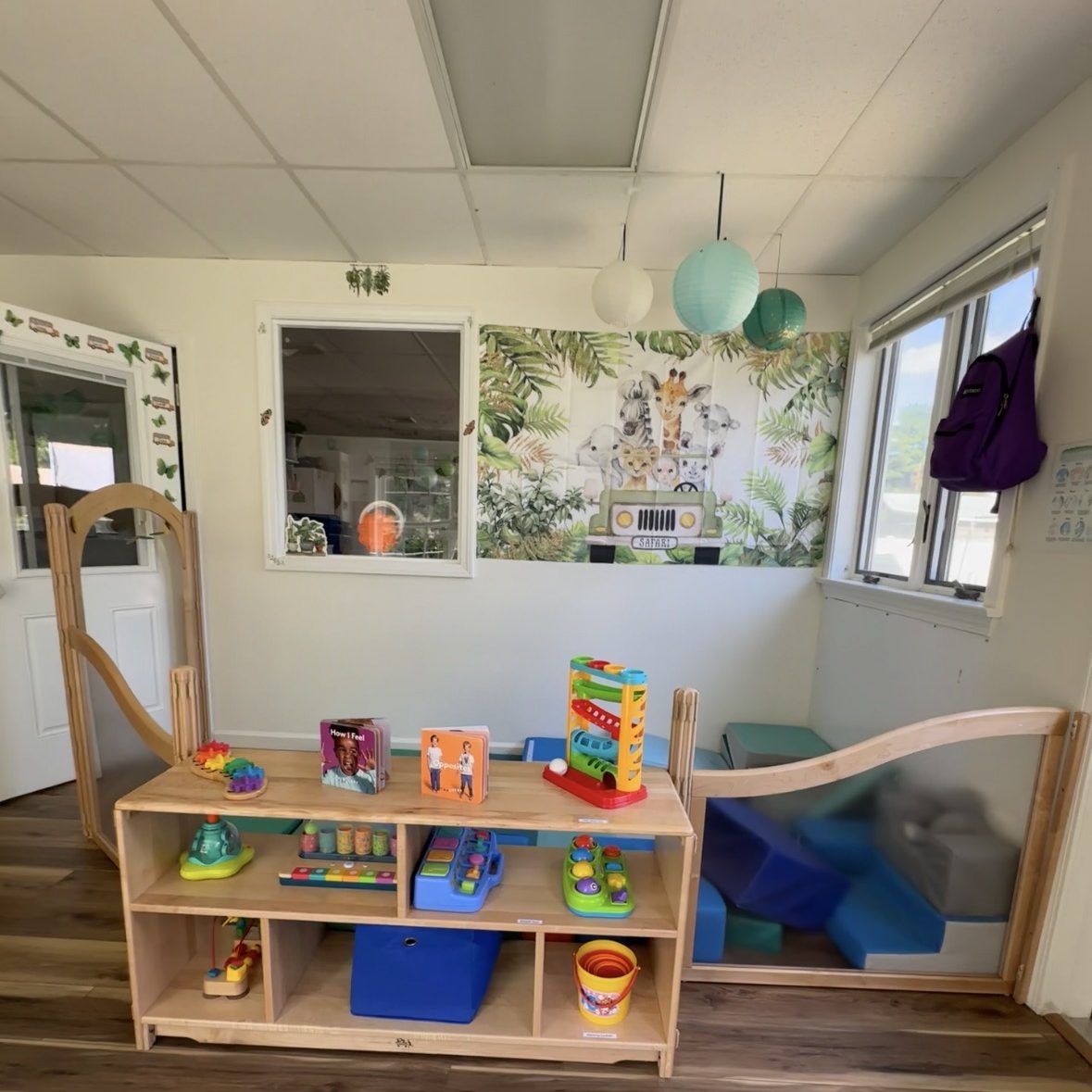 Selection of toys, and padded blocks in a play area.